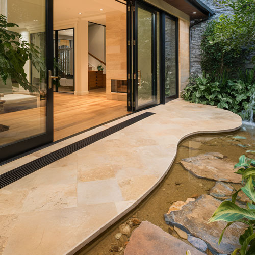 sliding glass doors opening to show the transition from indoor to outdoor flooring 