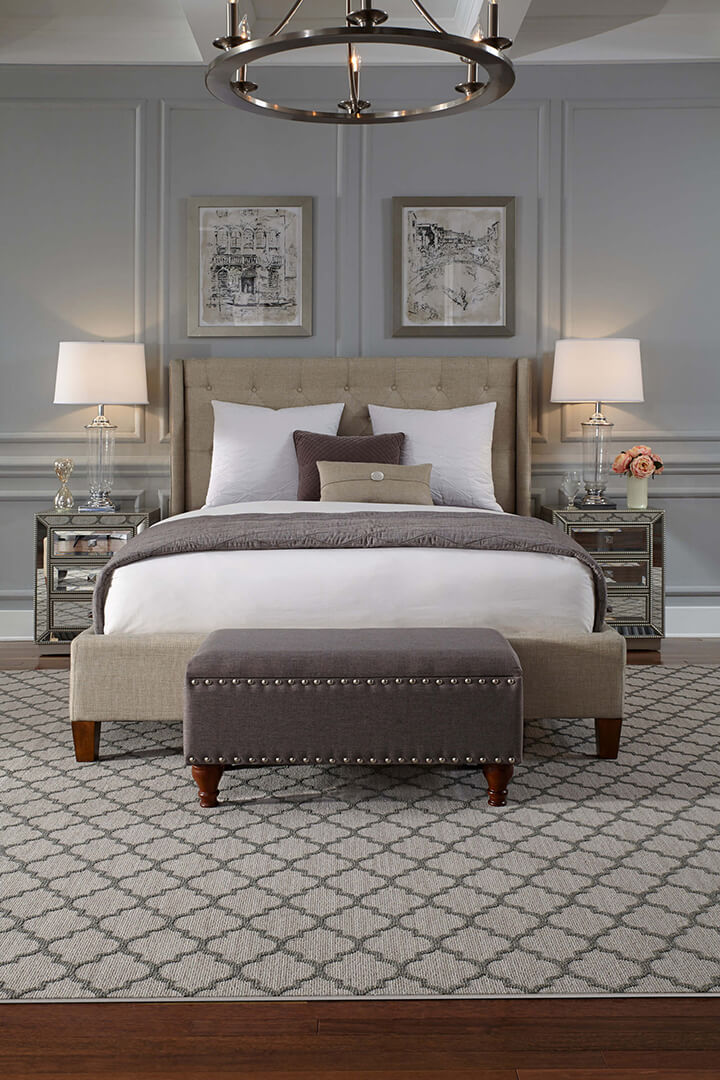 patterned area rug in neutral colors in complementary bedroom